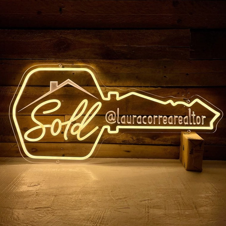 Skyline-inspired neon sign used for real estate branding
