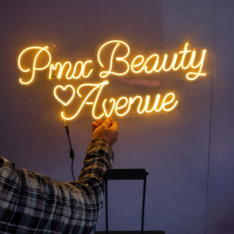 Pink lounge-inspired neon accent sign for a spa social area
